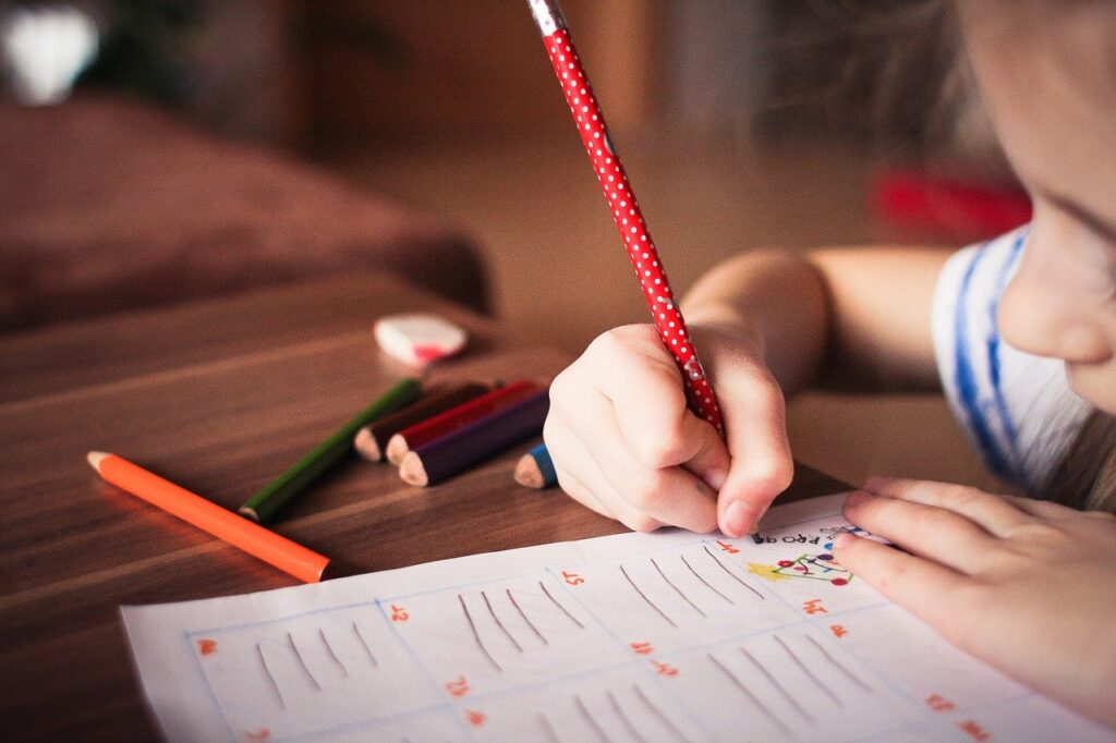 Child drawing  on an a piece of paper, an example of creativity