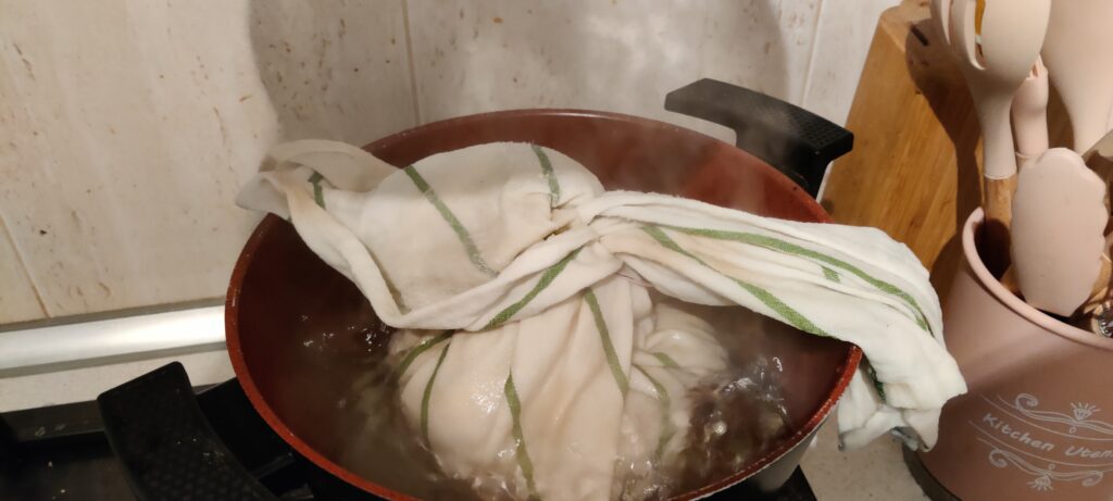 The dumpling is in a pot which filled with boiling water.