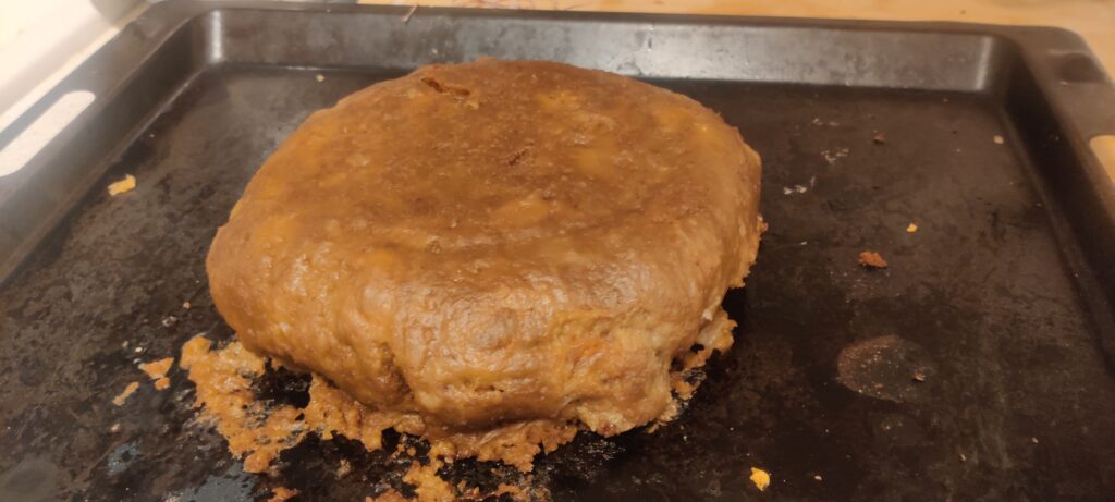 The clootie dumpling is now browned after being baked for a few minutes.