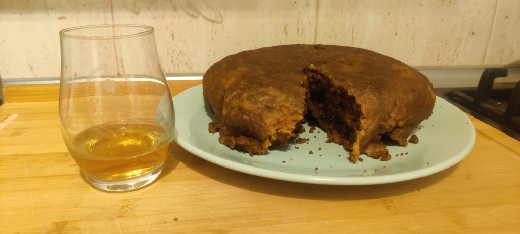 a glass of whisky next to the clootie dumpling.
